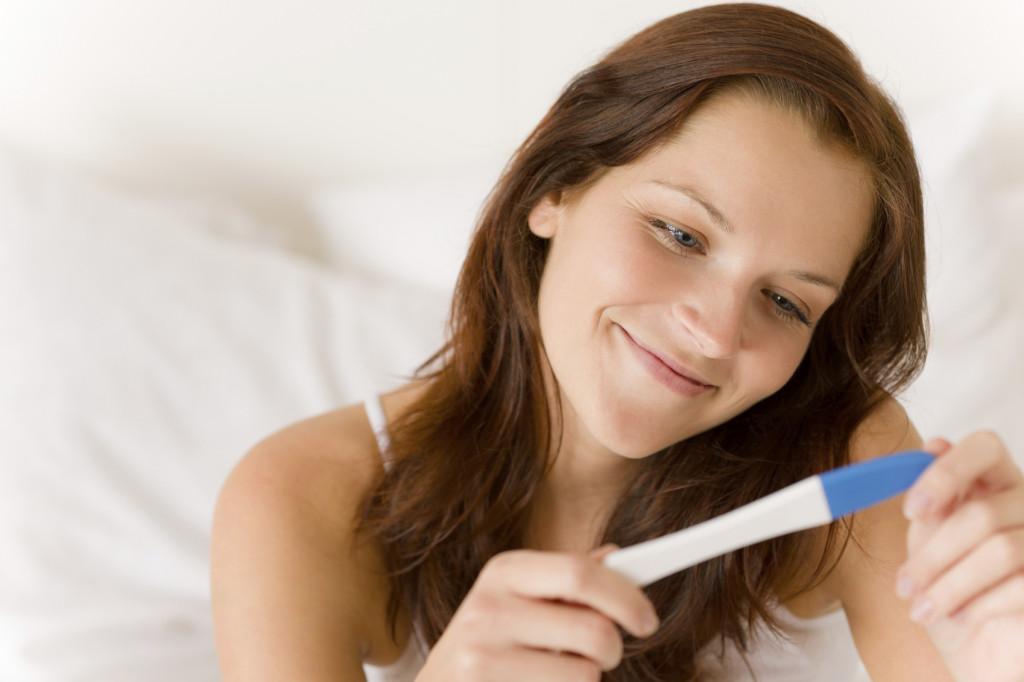 happy-woman-with-pregnancy-test
